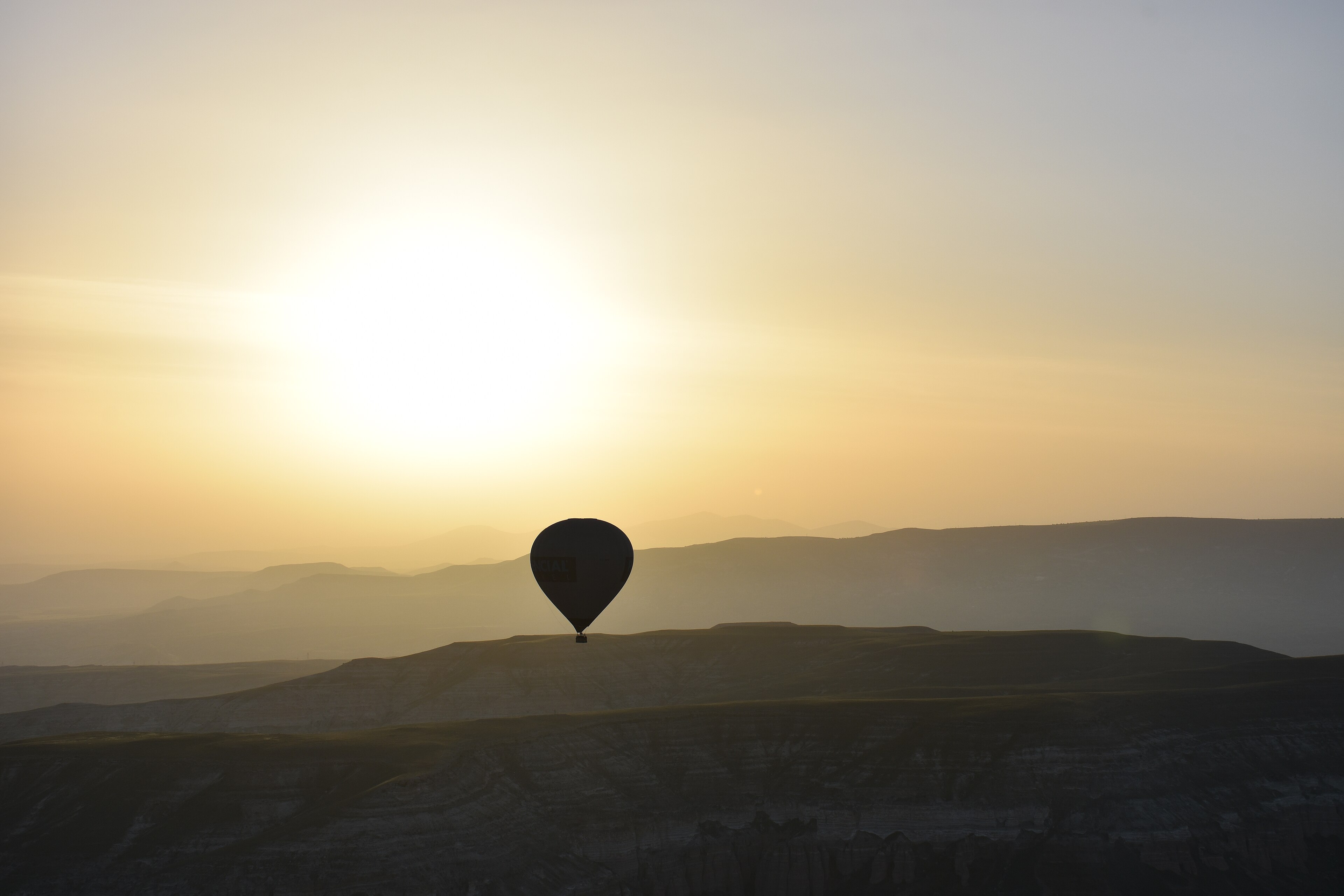 Hot air balloons rising at sunrise over Cappadocia, Turkey